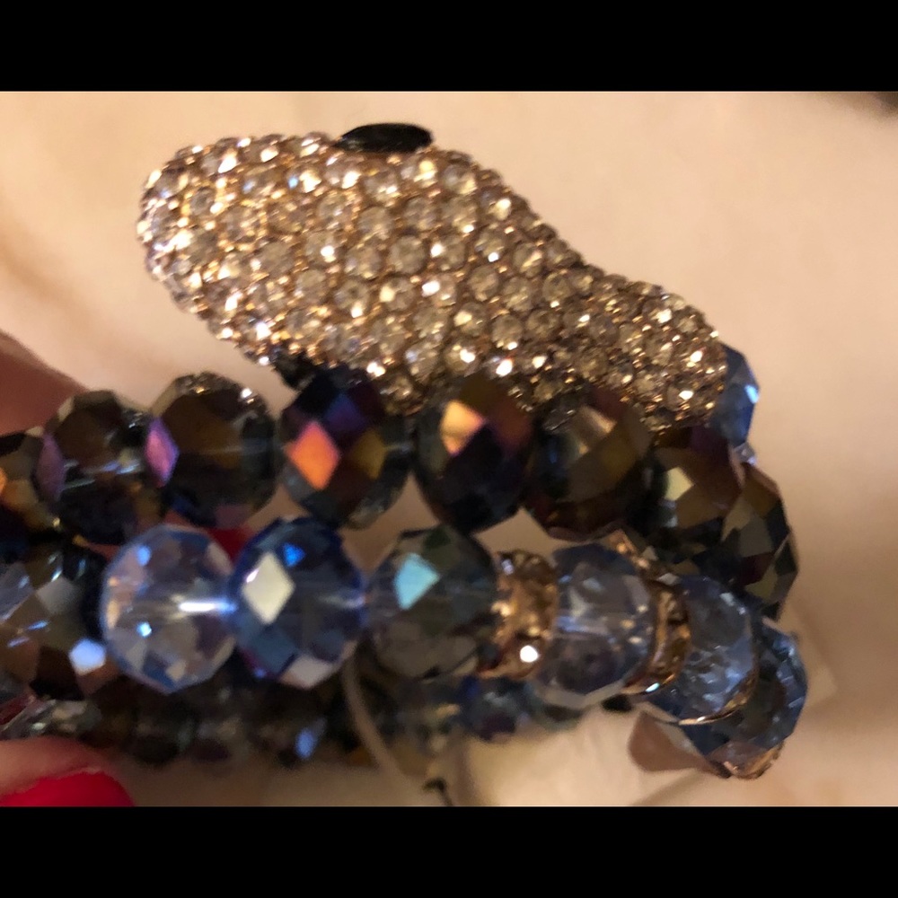 Rhinestone encrusted beaded snake coiled bracelet.